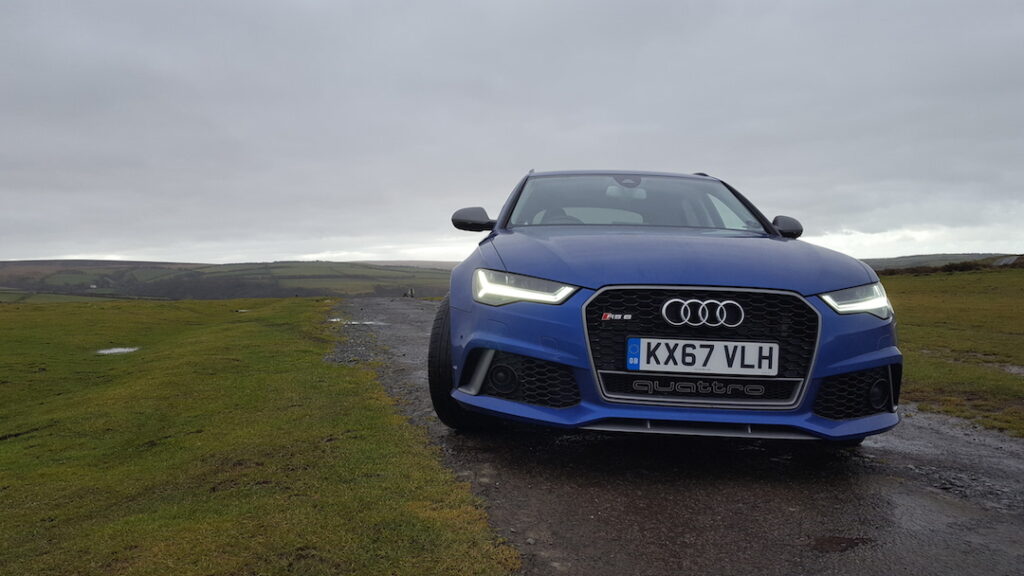 Front view of a blue Audi RS6 on an overcast day