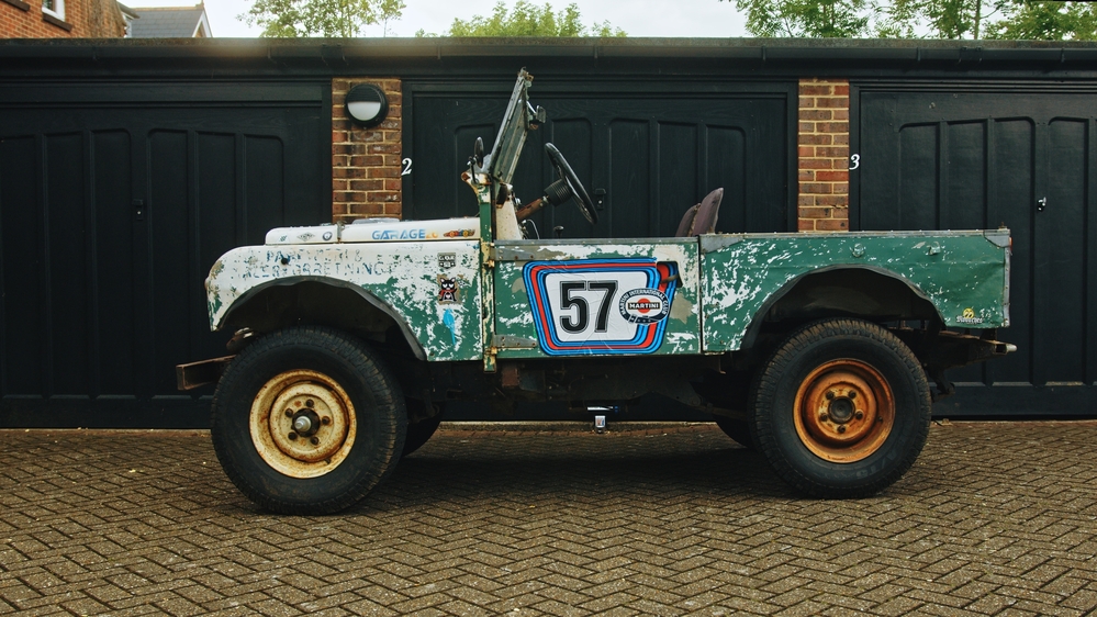 Ida, from the side, in front of a row of garages